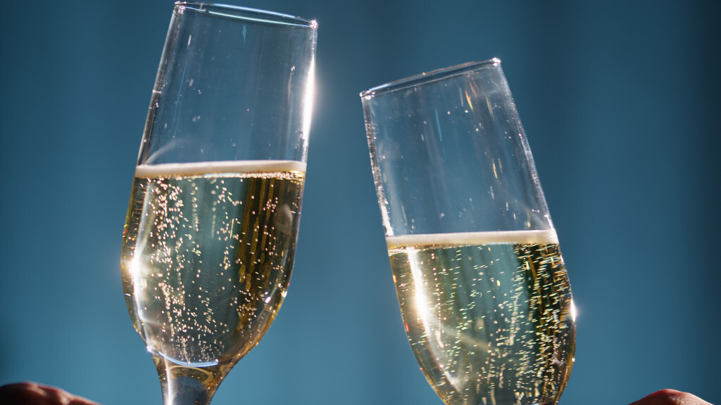 Verres de champagne pétillants sur fond bleu
